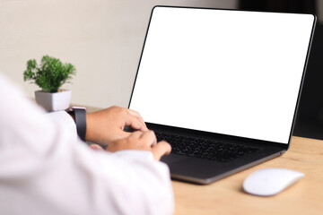 Mockup laptop computer. Business woman using laptop with empty screen on wooden table.