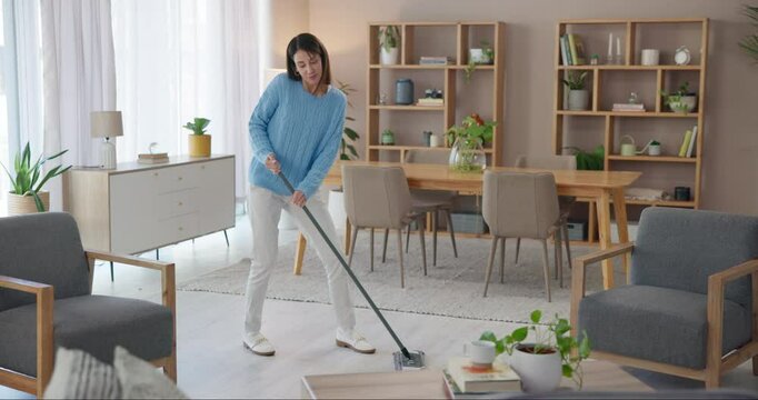 Woman, dancing or sweeping to clean home with broom for floor, ground or hygiene in living room. Girl, person or happy cleaner with spring cleaning music for working to stop dust, dirt or germs