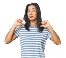 Young Latina posing in studio feels proud and self confident, example to follow.