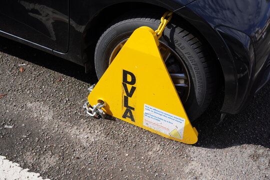 Southampton UK 8 September 2024 - A untaxed car with DVLA wheel clamp. Vehicle with wheel lock penalty 