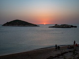 people wait for the dawn on the Adriatic Sea and Campi island. Baia and Cala Campi, Vieste, Gargano...