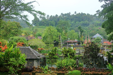 Bali in Indonesia - February 05 2024: people enjoy the Water Palace of Tirta Gangga in East Bali on a rainy day