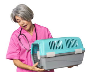 Middle-aged Caucasian female vet holding a carrier