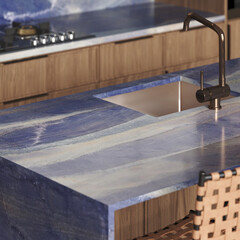 Modern kitchen design with quartzite countertop - detail of interior with faucet and home appliances. Azul Bouquira