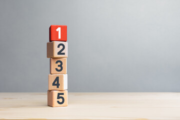 Wooden cubes with number first, second, third, fourth and fifth. 1st Business success champion,...
