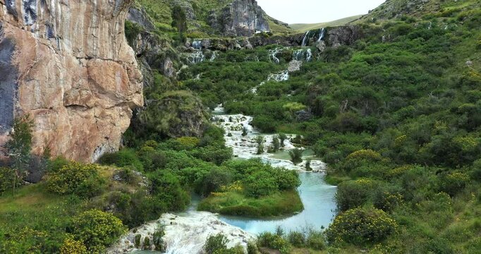 Beautiful shot with drone making an outward movement of the current of a lake with turquoise water in the afternoon called Millpu in Ayacucho, Peru.