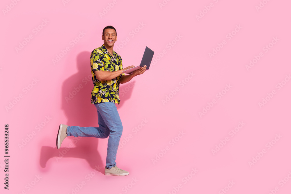 Sticker Full body photo of attractive young man running hold netbook dressed stylish tropical print clothes isolated on pink color background