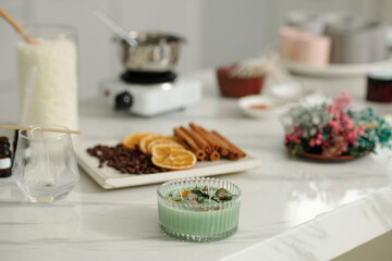 Handmade candle with aroma herbs on table in the room