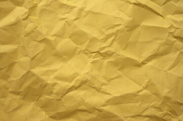 Full frame shot of crumpled yellow  paper sheet texture and background.