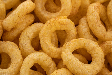 Crispy ring snacks isolated on white background. Corn onion rings in bowl isolated on white background. Crispy onion rings, isolated on white background. Snacks for watching movies.