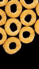 Crispy ring snacks isolated on white background. Corn onion rings in bowl isolated on white background. Crispy onion rings, isolated on white background. Snacks for watching movies.