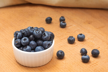 A bowl of fresh blueberries on a table, close-up