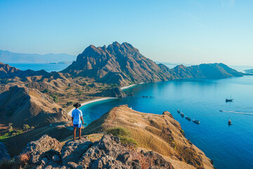 Man with amazing view of Padar island at Padar island in Komodo National Park, Indonesia. summer...