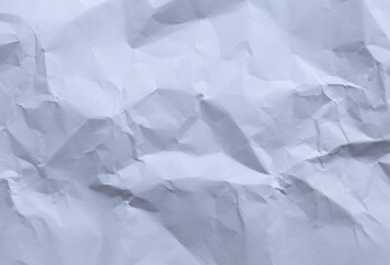 White crumpled paper forming an uneven textured background