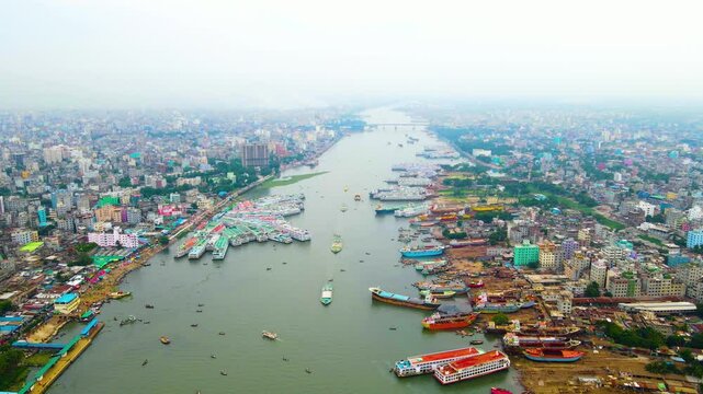 Aerial: Buriganga river port with shipyard by Dhaka city, Bangladesh. Elevated drone view