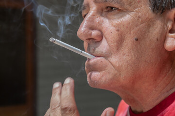 Fototapeta premium Smoker lighting a cigarette with lighter