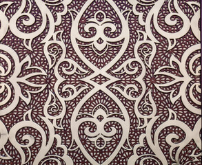 Fragment of an ancient carved wooden door. Ornate background.