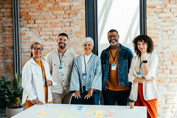 Multicultural young and senior professionals collaborating in a sophisticated business environment,...