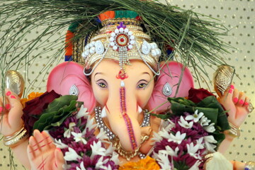lord ganesha idol on Ganesh chaturthi. highlighted face of shree ganesha. closeup. the temple is...