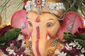 lord ganesha idol on Ganesh chaturthi. highlighted face of shree ganesha. closeup. the temple is...