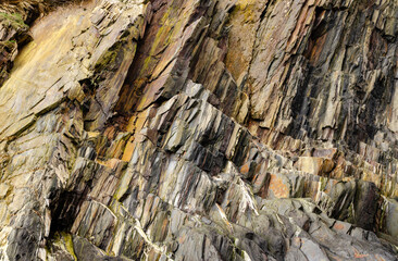 Close-up of sharp, jagged cliff faces with clear visible layers of rock.