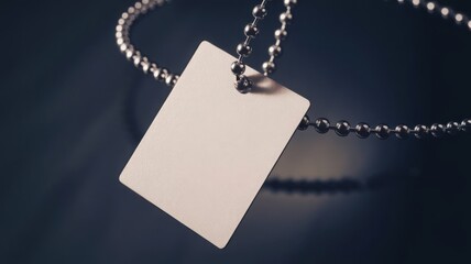 A realistic vector mock-up of a blank white square clothing label attached to a metal ball chain, serving as an empty price tag template for design purposes.