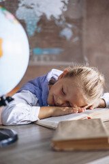 Schoolgirl sleeping at the desk in class