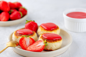 Cheesecakes, syrniki, cheese pancakes with berries, jam, cashew, and tofu in a plate, vegan food. Sugar, lactose and gluten free.