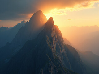 Naklejka premium A stunning sunrise bathes towering mountain peaks in warm golden light, casting long shadows across the rugged landscape. The soft gradient of light and mist in the distance enhances the serene beauty