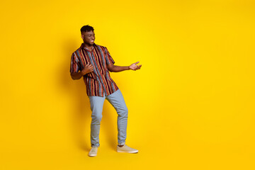 Full body portrait of nice young man dance play imagine guitar wear shirt isolated on yellow color background