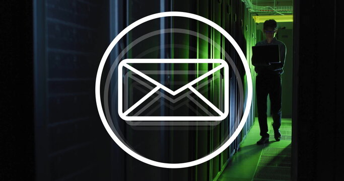Image of envelope email icon over male technician with laptop in dark computer server room