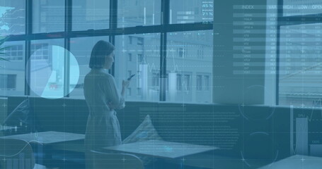 Image of financial data processing over asian businesswoman in office