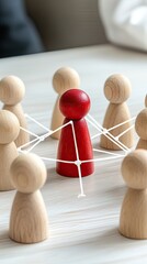 Obraz premium A red wooden figure stands at the core of a network, encircled by white figures against a blue background, illustrating the concept of leadership and collaboration