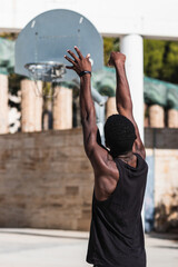 Young African American man playing basketball outdoor - Urban sport lifestyle concept