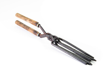 Ancient barber pair of tongs on white background. Vintage curling iron. beauty concept