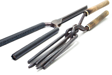 Ancient barber pair of tongs on white background. Vintage curling iron. beauty concept