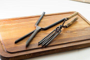 Obraz premium Ancient barber pair of tongs on white background. Vintage curling iron. beauty concept