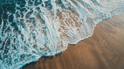 of beach waves creating patterns on sand with copy space
