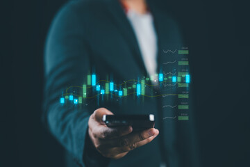 A businessman's or trader's hand is showing a growing virtual hologram stock on a smartphone, indicating an investment in trading. concept of investment management. strategy finance success wealth,
