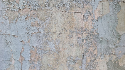 Peeling paint on an old wall. Grunge background for design.Selective focus