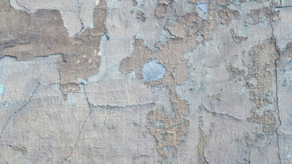 Peeling paint on an old wall. Grunge background for design.Selective focus