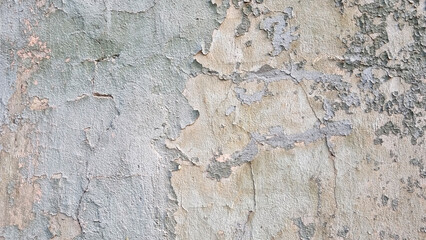 Peeling paint on an old wall. Grunge background for design.Selective focus