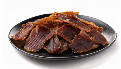 Obraz premium Dried beef and pork slices on plate, beer snacks or dog treats on white backdrop. Tasty food.