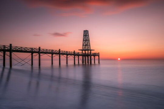 Pontoon On The Mediterranean Sea At Sunrise, In The Coastal Town Of Port Leucate, France. The Well-known Pontoon In The Town Of Port-leucate, In The South Of France. Long Exposure.