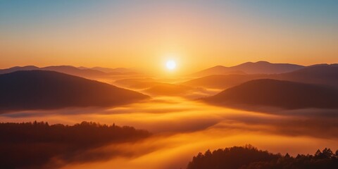 Naklejka premium A serene sunrise illuminating misty valleys and hills, creating a tranquil landscape filled with nature's beauty.