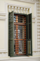 green shutters on the windows building facade with wooden decor