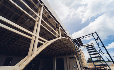 A structure featuring wooden slats on construction site contributing to its architectural style