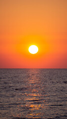 Shiny sun rising from the water at the Black Sea
