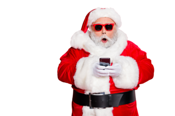 Portrait of impressed christmas father in hat using cell phone  device screaming omg wearing read about festive events eyeglasses eyewear belt isolated over red background