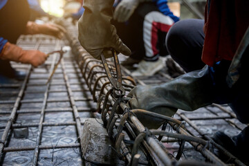 A group of builders is busy constructing a metal structure
